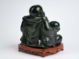 statue of a man and a woman sitting on a wooden platform