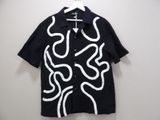 the shirt is black and white with white swirls on it