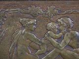 a bronze plaque with a picture of a man and a woman holding a baby