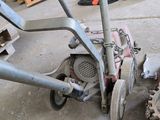 a machine that is sitting on the ground in the garage