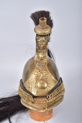 an old helmet with a long black hair on a white background