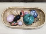 a wicker basket filled with assorted stones and beads