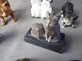 many small figurines of cats and dogs on a table