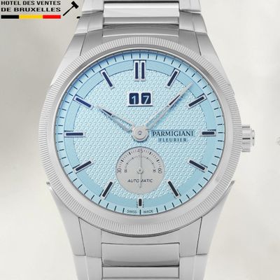 a close up of a watch with a blue dial