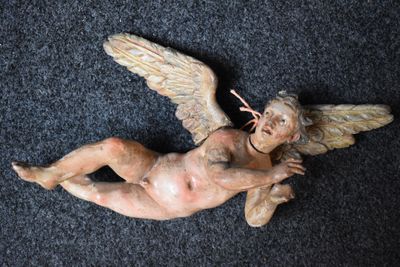 a statue of an angel on a black carpet