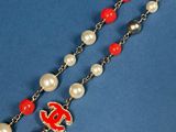 a close up of a rosary with red and white pearls