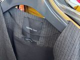 a close up of a suit hanging on a hanger