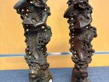 pair of bronze statues of a woman and a man on a pedestal