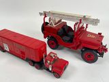two toy trucks that are sitting next to each other