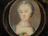 portrait of a woman in a blue dress with a flower in her hair