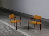 two chairs that are sitting in the middle of a room