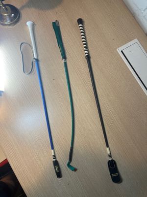 three different colored toothbrushes sitting on a table