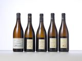 six bottles of wine are lined up on a table