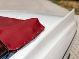 a close up of a car ' s hood with a red cover on it