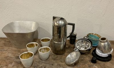 a lot of coffee pots and cups sitting on a table