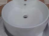 a white sink sitting on top of a cardboard box