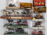many different types of toy cars and carriages on display