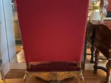 an image of a red chair sitting on top of a hard wood floor
