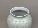 a white vase that is sitting on a table