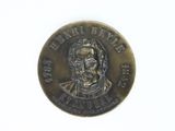 an old bronze coin with a portrait of a man on it