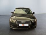 the front view of a black audi parked in a large room