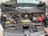 a man working on the engine of a car