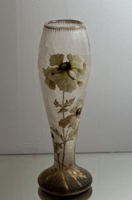a glass vase with a flower inside of it on a table