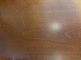 a close up of a wooden table with a clock on it
