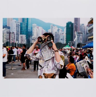 a man that is holding a camera up to his face