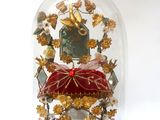 a glass dome with a red cushion inside of it