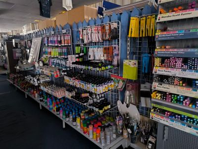 many pens and markers on the shelves in the store
