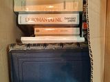 many books stacked on top of each other in a box