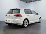 the rear of a white volkswagen e - golf parked in a garage