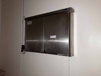 an image of a metal wall mounted cabinet in a bathroom