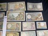 a lot of different types of paper money on the table