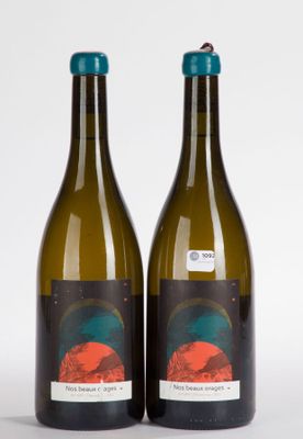 two bottles of wine are sitting next to each other on a white surface