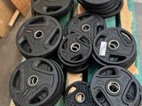 black cast iron weights sit on pallets in a warehouse
