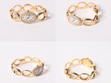 three gold tone rings with white stones on each side