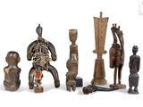 several pieces of african art are displayed on a white surface