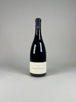 une bouteille de vin posée sur une table blanche