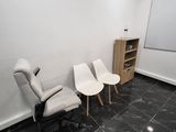 three chairs in a room with a white board on the wall