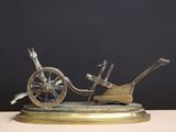 bronze sculpture of a horse drawn carriage on a marble base
