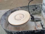 a metal bucket with a white frisbee inside of it