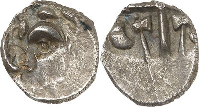 a close up of two silver coins on a white surface