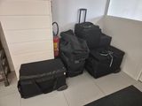many pieces of luggage sitting on the floor in a room