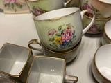 many cups and saucers sitting on a table
