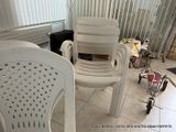 two white plastic chairs sitting next to each other on a tiled floor