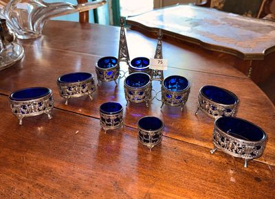 a table with a bunch of blue glass bowls on it