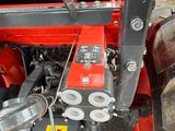 a red tractor that is parked on the side of the road