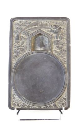 an old silver plate with a picture of a woman on it